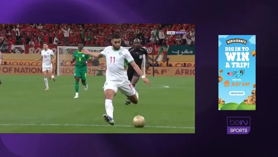 A football broadcast squeezed to one side, with a tall ad in the freed-up space beside it